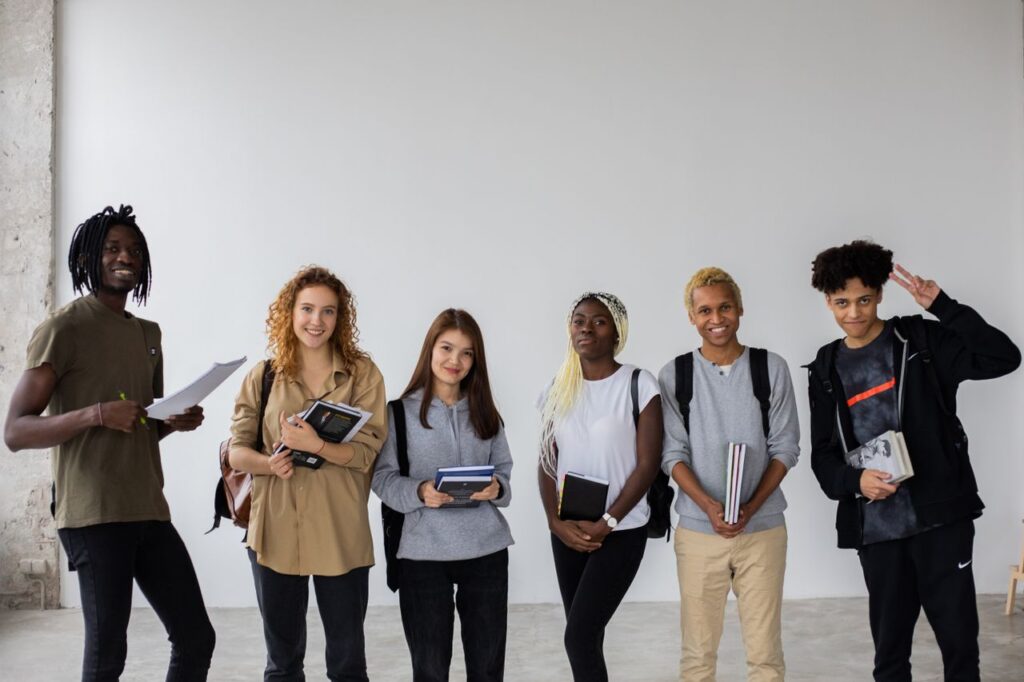 The Art of Drawing Readers In: Your attractive post title goes here Group of smiling multiracial classmates standing with books and backpacks and smiling widely at camera